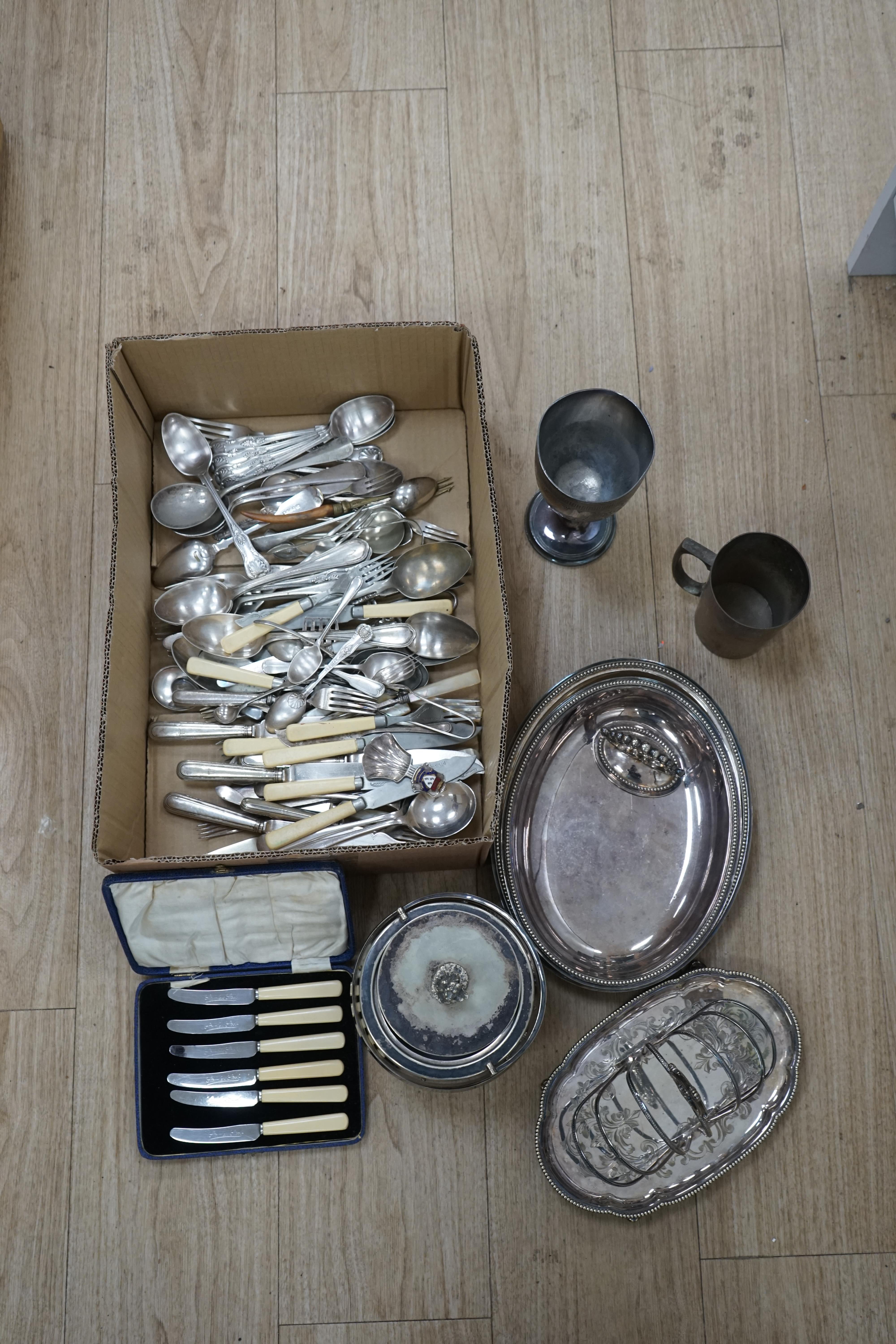 Assorted plated wares to include flatware, toast rack, biscuit barrel and goblet. Condition - fair